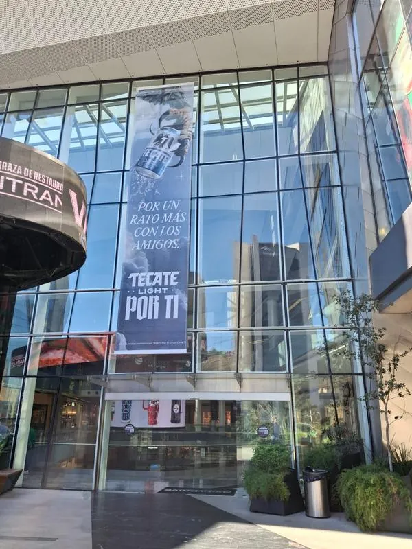 Lona publicitaria Tecate Light instalada en entrada Fashion Drive San Pedro